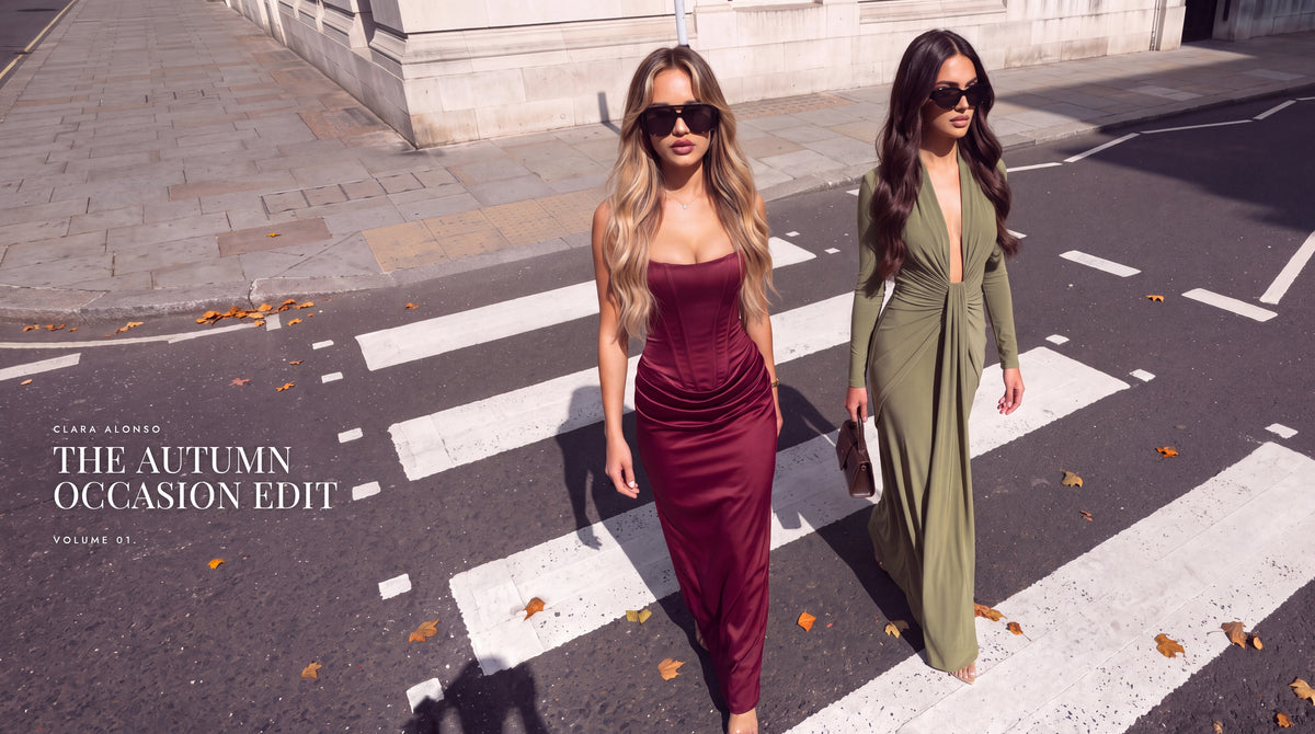 The Autumn Occasion Edit by Clara Alonso: two women crossing a city street in a wine red satin corset maxi dress and an olive green V-neck maxi dress