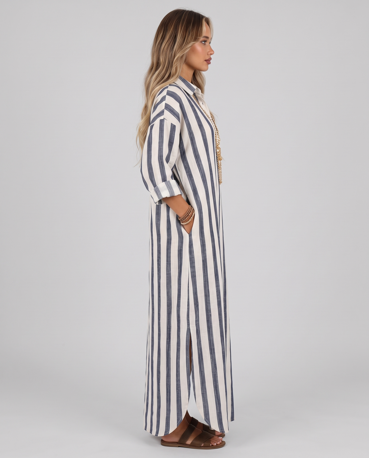 Blue and off-white striped long shirt dress, side view showing the relaxed fit and side split