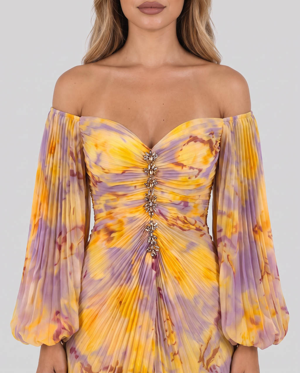 Close-up of the off-shoulder sweetheart neckline, jewelled centre front and pleated balloon sleeves