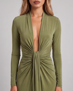 Close-up of the plunging V-neckline and ruched waist of the olive green dress