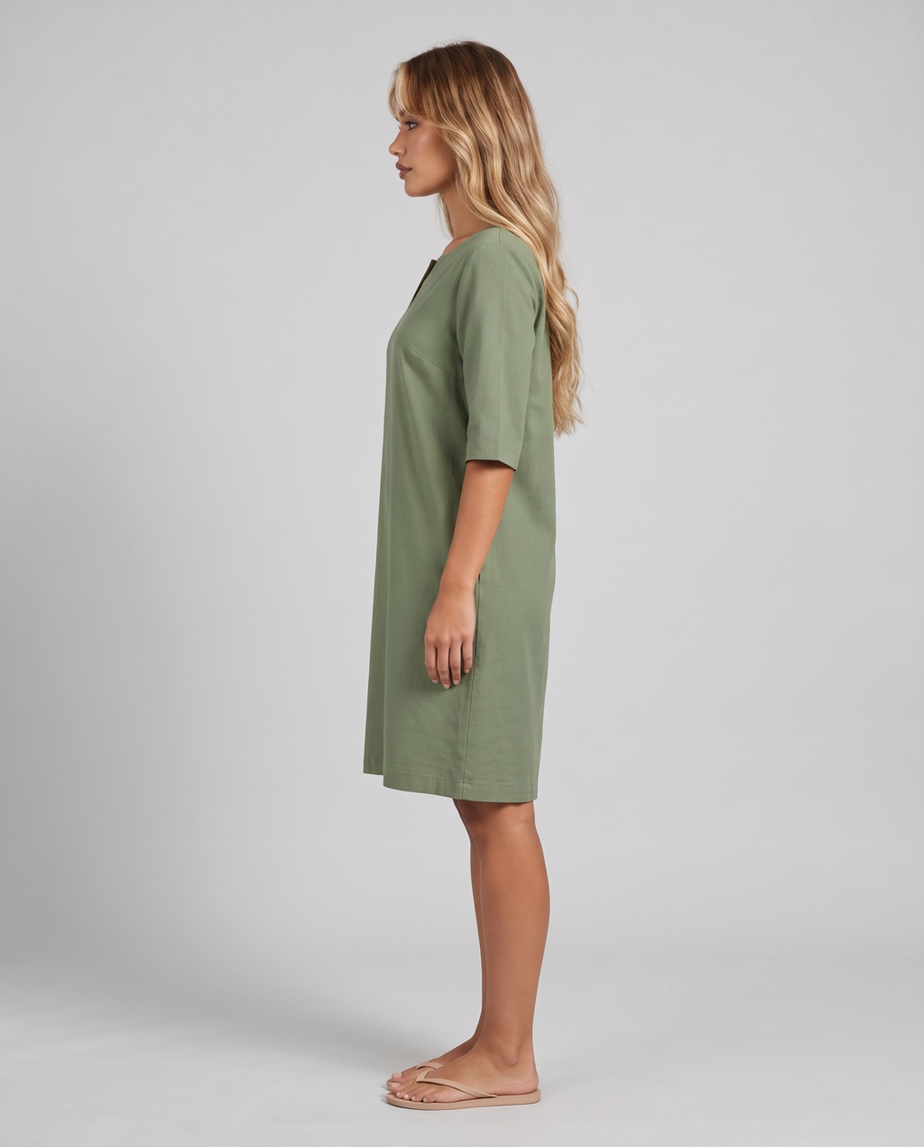 Green V-neck knee-length shift dress, side view