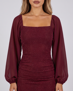 Close-up of the square neckline, chiffon balloon sleeves and glitter fabric