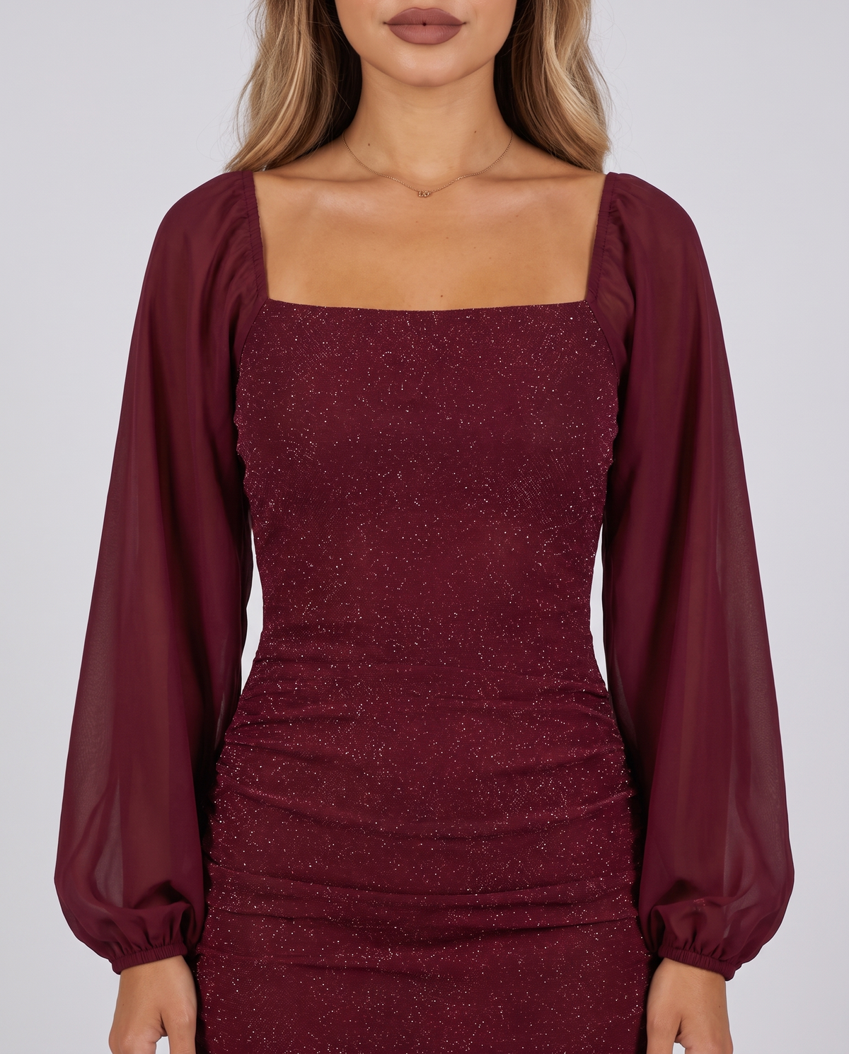 Close-up of the square neckline, chiffon balloon sleeves and glitter fabric